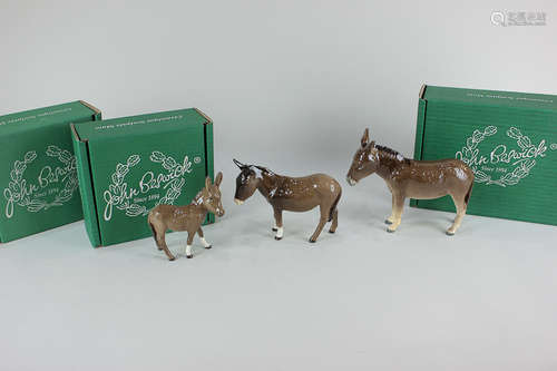 Two Beswick models of donkeys, tallest 14cm, together with a Beswick donkey foal, 11.5cm, all in