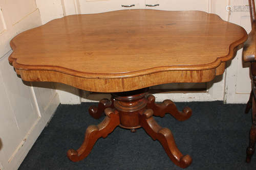 A Victorian oval shaped pedestal table, on outswept legs to scroll feet, 136cm