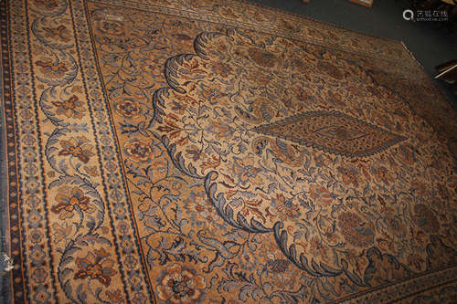 A large wool carpet with birds and scrolling floral design, in blue and orange on beige ground (a/f)