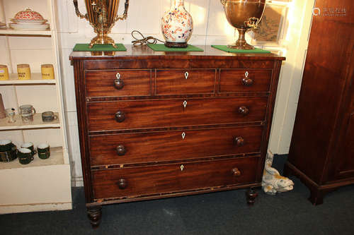 A Georgian mahogany chest of four drawers, with turned knob handles and diamond shaped bone