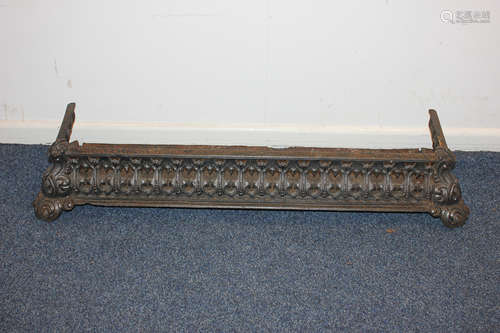 A Victorian cast iron fire fender with pierced decoration, on scroll feet, 96cm