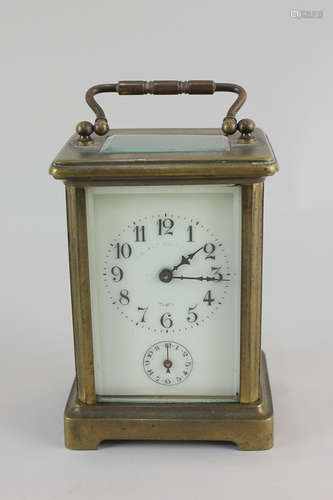 A French brass and bevelled glass cased carriage clock, the enamel dial with Arabic numerals and