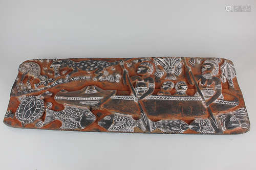 An Indonesian carved hardwood panel depicting a family in a canoe with animals around, 70cm by 24.