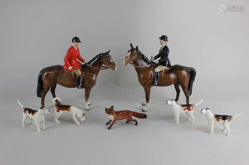 A Beswick hunting group comprising huntswoman, huntsman, a fox and four hounds (a/f)