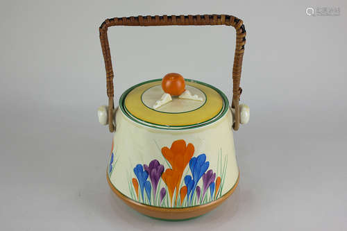 A Bizarre by Clarice Cliff crocus pottery biscuit barrel with wicker handle, 19cm