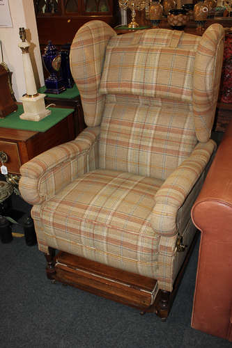 A Victorian reclining wing armchair by J Foot & Son Ltd, with an adjustable back and folding