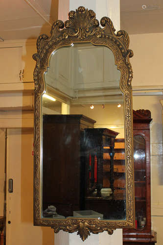 A Georgian style gilt framed wall mirror with shell and scroll surmount, 97cm