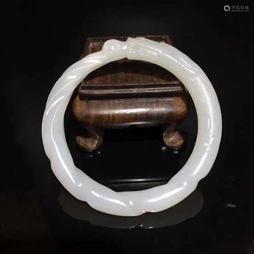 A WHITE JADE CARVED BANGLE