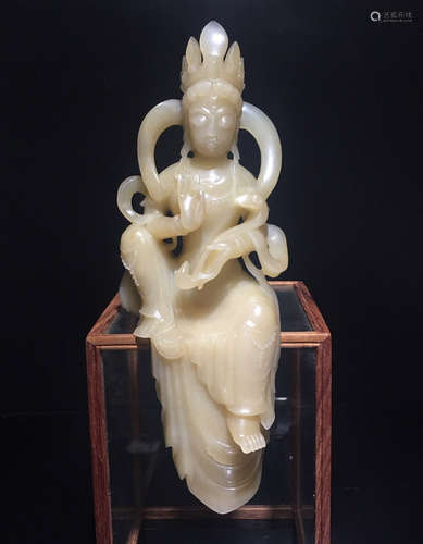 A HETIAN JADE CARVED SITTING GUANYIN FIGURE