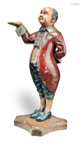 An early 20th century carved and polychrome-painted figural dumb waiter