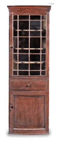 A George III joined pine 'scumbled' and astragal-glazed bow-fronted upright cupboard, circa 1790