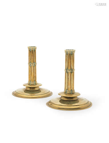 Four rare mid-17th century cast and sheet brass round-based and cluster-stemmed socket candlesticks, Dutch or English, circa 1660