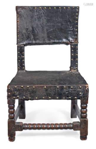 A Charles II joined oak, pine, elm  and hide-upholstered low chair, circa 1680 and later