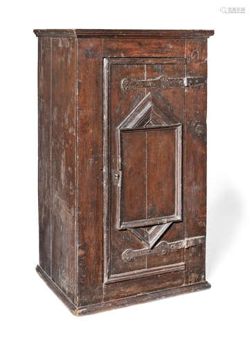 A mid-17th century boarded oak livery cupboard, German, circa 1650