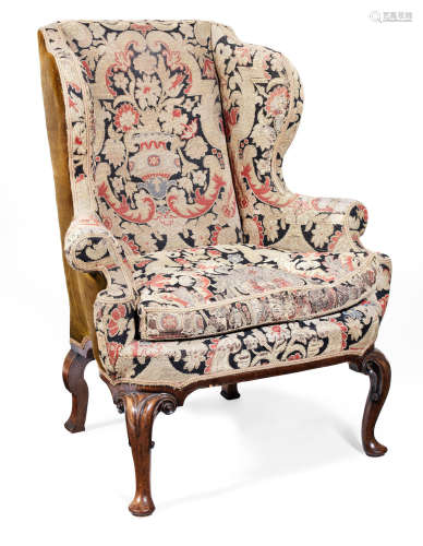 In the circa 1725 manner A George I style walnut and upholstered winged armchair,