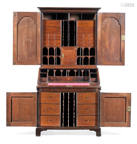 With a well-fitted practical interior  A good George I joined oak desk cabinet, circa 1725