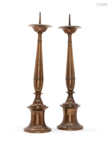 A tall pair of alloy pricket candlesticks