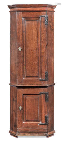 A particularly narrow George II joined oak standing corner cupboard, circa 1730-50