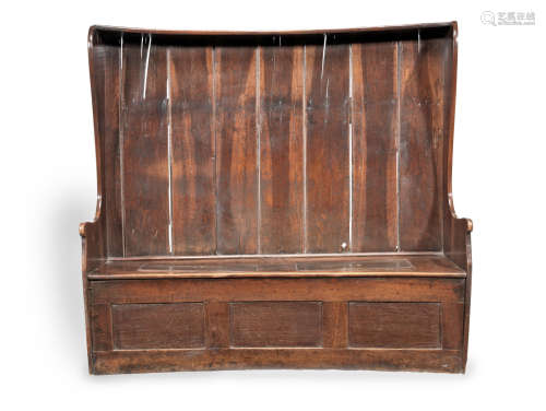 A George III boarded oak canopy high-back bowfronted settle, West Country, circa 1780
