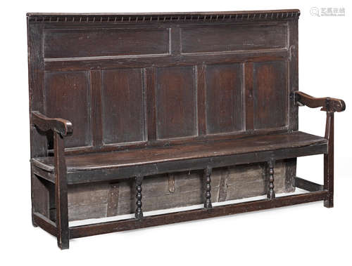 A Charles II joined oak panelled-back open settle, circa 1670