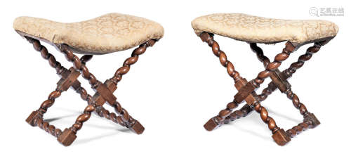 A pair of walnut and upholstered stools, Flemish, circa 1700