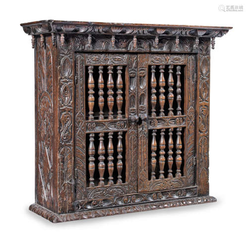 An interesting Charles I joined oak, elm and fruitwood mural spindle cupboard, West Country, circa 1640