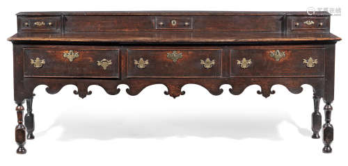A George I joined oak and fruitwood open dresser base, circa 1715