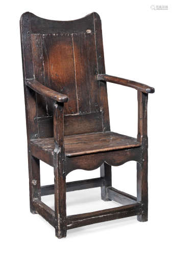An early 18th century joined and boarded oak open armchair, Welsh, circa 1720