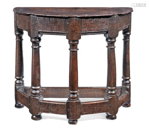 A rare and exceptionally small early 17th century joined oak and walnut 'half-round' table, English, circa 1600-30