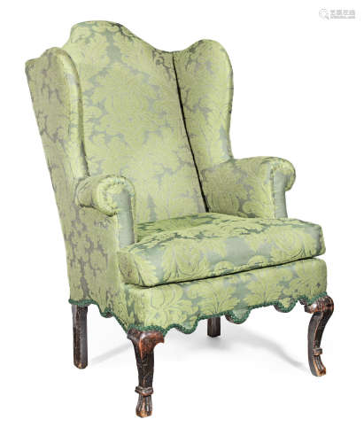A George I oak-framed and upholstered wing armchair, circa 1720