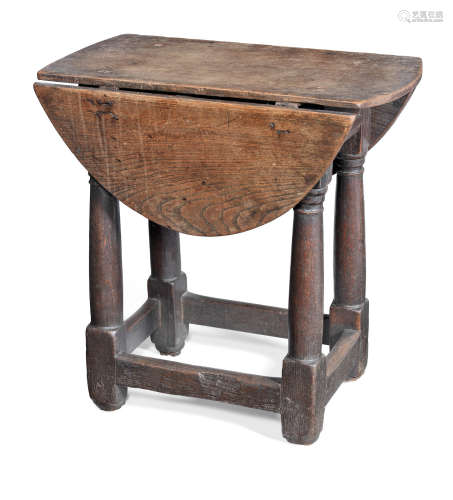A mid-17th century boarded elm and joined oak table-stool, English, circa 1650