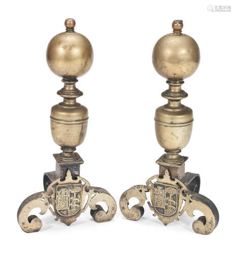 A pair of late 17th/early 18th century and later brass and wrought iron firedogs, Dutch