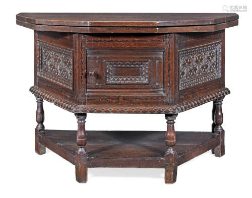 A large Charles I joined oak and inlaid enclosed cupboard, with fold-over top, circa 1640