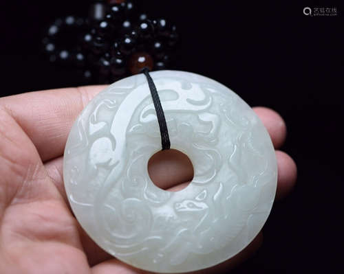 A HETIAN JADE CARVED CIRCLE PENDANT