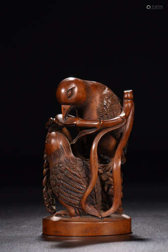 A HUANGYANG WOOD CARVED PARROT SHAPED PENDANT