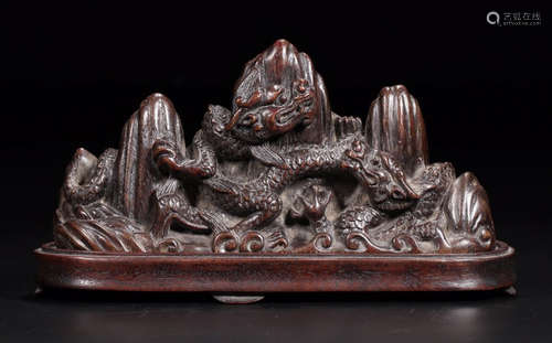 A CHENXIANG WOOD CARVED MOUNTAIN SHAPED PEN SHELF