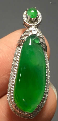 A GREEN JADEITE CARVED PENDANT, A CLASS