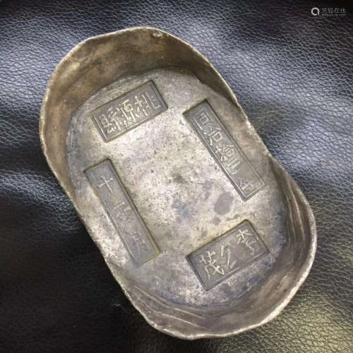 A SILVER CARVED INGOT
