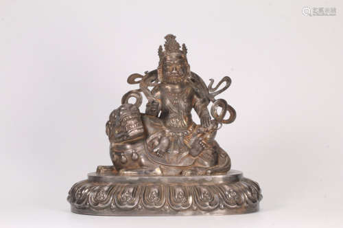 A SILVER CARVED WEALTH BUDDHA