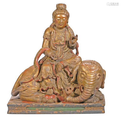A carved wood figure of Samantabhadra seated on an elephant