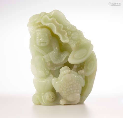 A jadeite carving pale green depicting boy playing with a toad