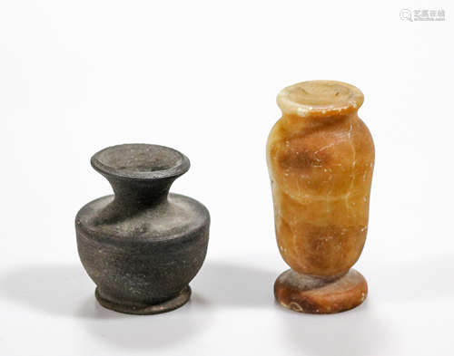 A pair of ancient artifacts, terracotta miniature vase and alabaster cosmetic vessel