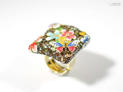 A large high quality gold over sterling enameled designer ring depicts flowers