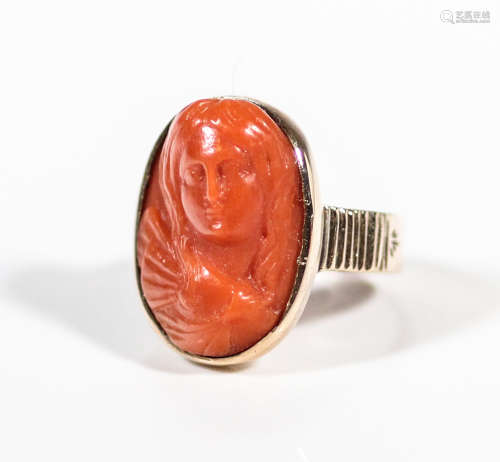 A Victorian red coral ring set in 14kt gold, depicting a female bust