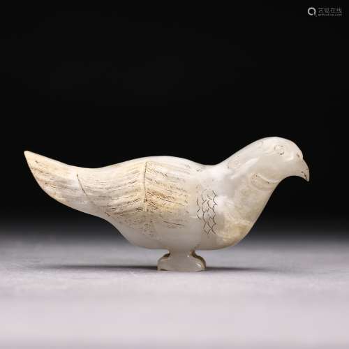 A WHITE JADE FIGURE OF A SEATED BIRD