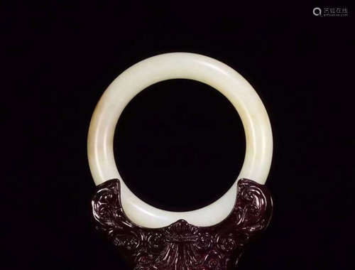 A HETIAN JADE BRACELET WITH STAND