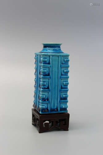 Chinese turquoise glaze porcelain vase on a wood stand.