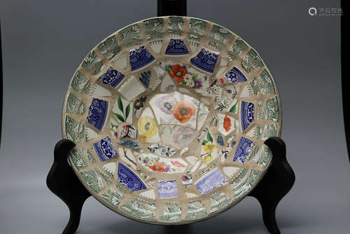 Pottery dish decorated with ceramic pieces.