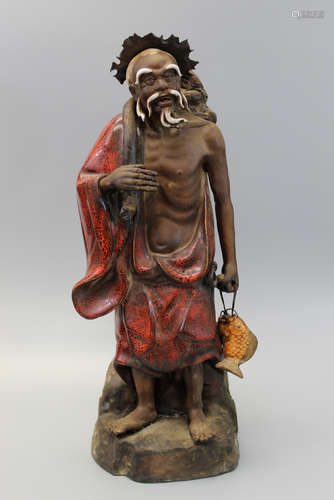 Chinese pottery figure of a fisherman.