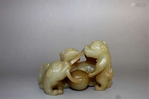 Chinese carved jade dogs playing a ball.